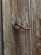 Aged door handle on wooden door