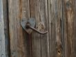 Aged door handle on wooden door