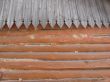 Old log wall and wooden roof