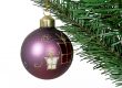 Purple christmas ball over a tree