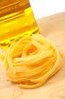 Uncooked pasta nest and oil