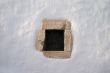 small window  in white lime wall