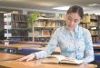 Beautiful woman reading a book in the library