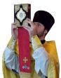 Orthodox priest rising ancient Holy Gospel