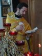 orthodox priest praying with Gospel in hands