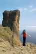 Girl on the rock above the sea