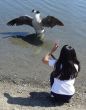 Girl talking to a goose
