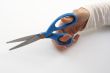 A hand holding scissors