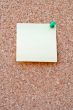 Yellow postit on a corkboard