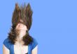 crazy womans hair over a blue background