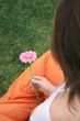 girl holding a beautiful flower from the back