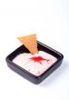 Dessert creamy with cracker on black plate
