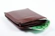Old leather wallet with bills inside