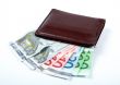 Old leather wallet with bills inside