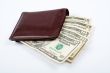 Old leather wallet with bills inside
