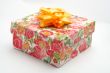 Gift box with yellow ribbon, on white background