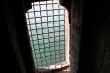 Grilled castle window overlooking the sea