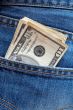 Ten dollars bills in a jeans pocket