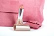 lipstick and Assortment of pink handbags