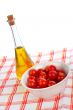 Olive oil bottle and red tomatos cherry