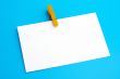 Isolated white paper with yellow clamp
