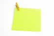 Isolated green paper with yellow clamp