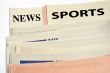 Stacked sports newspapers