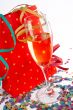 Champagne glass with red shopping bag