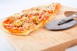 Detail of slices Italian pizza and cutter