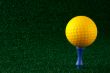 Yellow golfball and blue tee