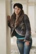 young woman leans at a pillar