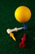 Yellow golfball and tees