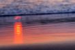 red rays of sunlight on the sand