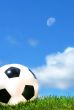 Closeup of a soccerball against a blue sky