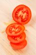 Sliced tomatoes on wood background