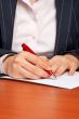 Business woman writing a contract