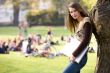 leaning against a tree with notebook