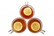Three glass cups of tea with one slice of lemon
