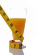 A glass of juice with a metric coiled tape