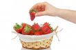 Takes a strawberry of the basket