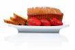 Slices of cake with three strawberries