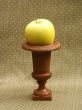 yellow green apple on small pedestal