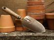 garden trowel leaning on flower pots