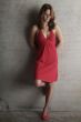 woman leans against a wall