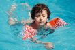 boy learning to swim