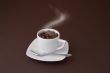 steaming coffee cup with beans