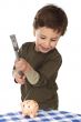 adorable boy breaking the money box