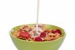 Cornflakes with milk being poured