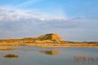 Hill over the blue sky and the lake