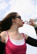 sporty girl drinking water - fitness